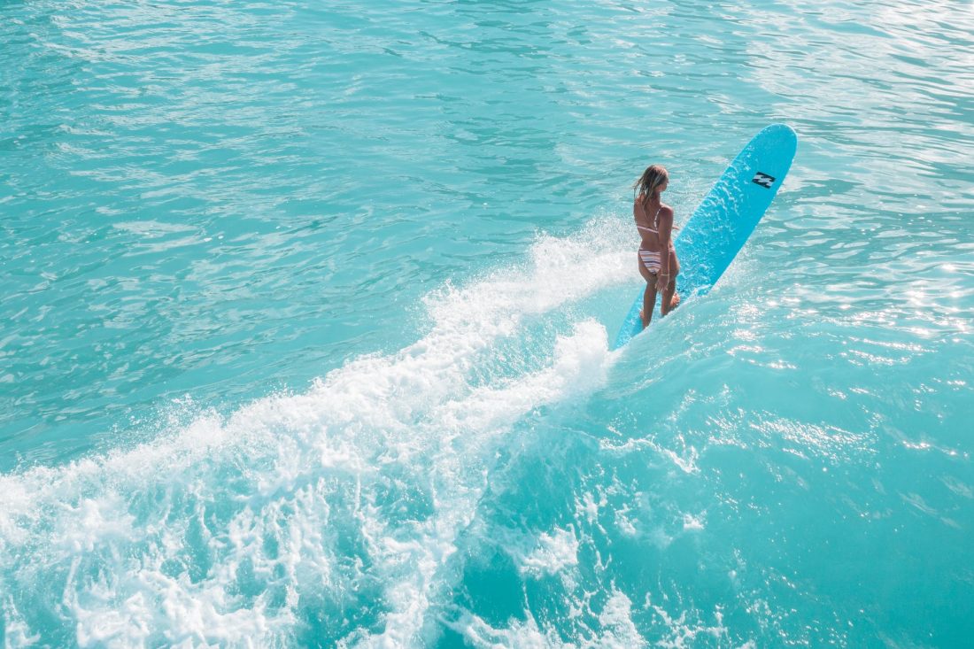 a woman in a bikini surfing